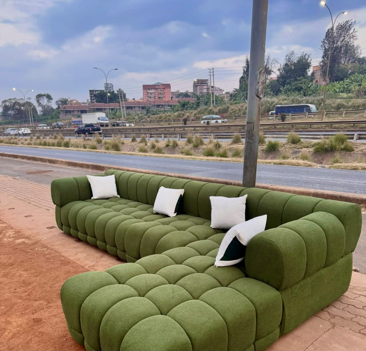 Green modular sofa with white scatter cushions